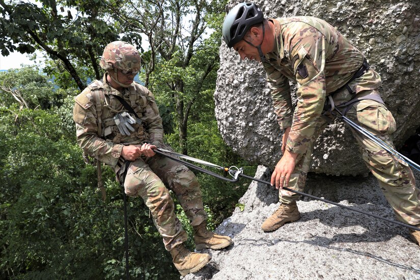 Approximately 25 Soldiers with 1st Squadron, 104th Cavalry Regiment, 2nd Infantry Brigade Combat team, 28th Infantry Division, Pennsylvania Army National Guard, conducted rappel training June 13 at a rock formation near Fort Indiantown Gap known as Boxcar Rocks. The Soldiers used mountain warfare skills to ascend the north face of the Boxcar Rocks safely with harnesses and ropes, then rappelled down the south face approximately 100 feet. (U.S. Army National Guard photo by Sgt. 1st Class Zane Craig)