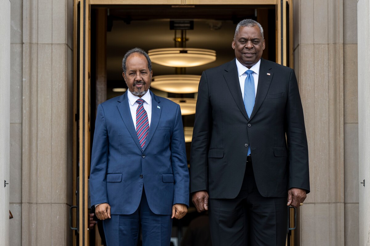 Two men pose for a photo on the Pentagon steps.