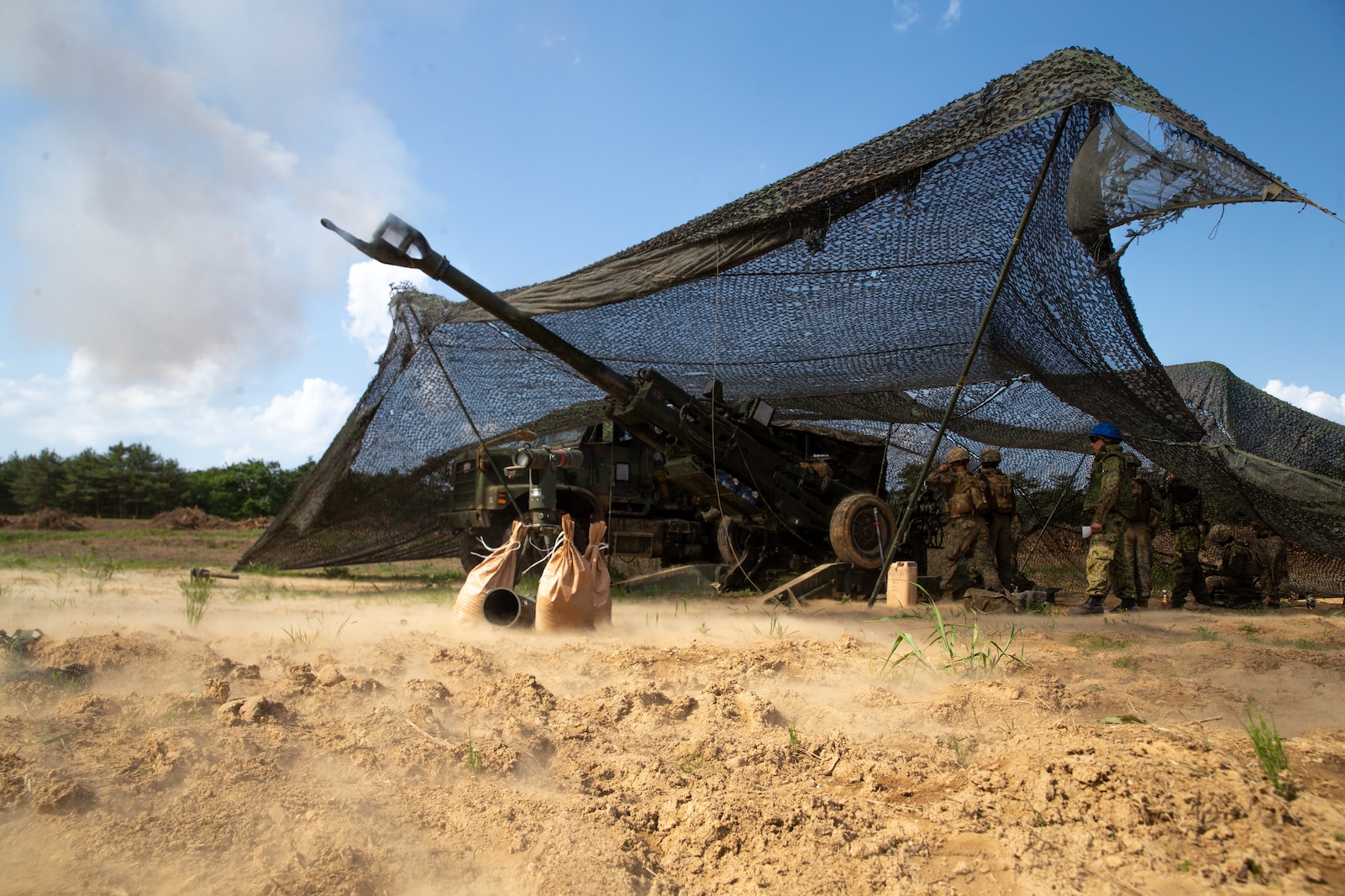 U.S. Marines fire a M777 Howitzer during Artillery Relocation Training Program 23.1 at Ojojihara Maneuver Area, Miyagi, Japan, May 27, 2023. ARTP provides Marines the opportunity to rehearse live-fire operations across a range of climates and conditions, providing lethal combat ready forces in the Indo-Pacific. The Marines are currently deployed with 3d Battalion, 12th Marines, 3d Marine Division. (U.S. Marine Corps photo by Cpl. Michael Taggart)