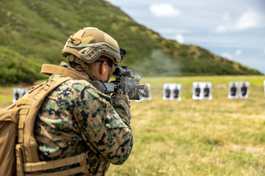 U.S. Marine Corps Lance Cpl. Merek Katzenmeier, an infantry Marine with 3d Littoral Combat Team, 3d Marine Littoral Regiment, 3d Marine Division, fires an M27 Infantry Automatic Rifle during a scout platoon screener at Marine Corps Base Hawaii, June 4, 2023. The screener evaluates Marine’s abilities to execute basic skills, learn and retain information, and improve scores over repetitious evaluations to identify Marines who will be successful in the future scout platoon. (U.S. Marine Corps photo by Sgt. Israel Chincio)