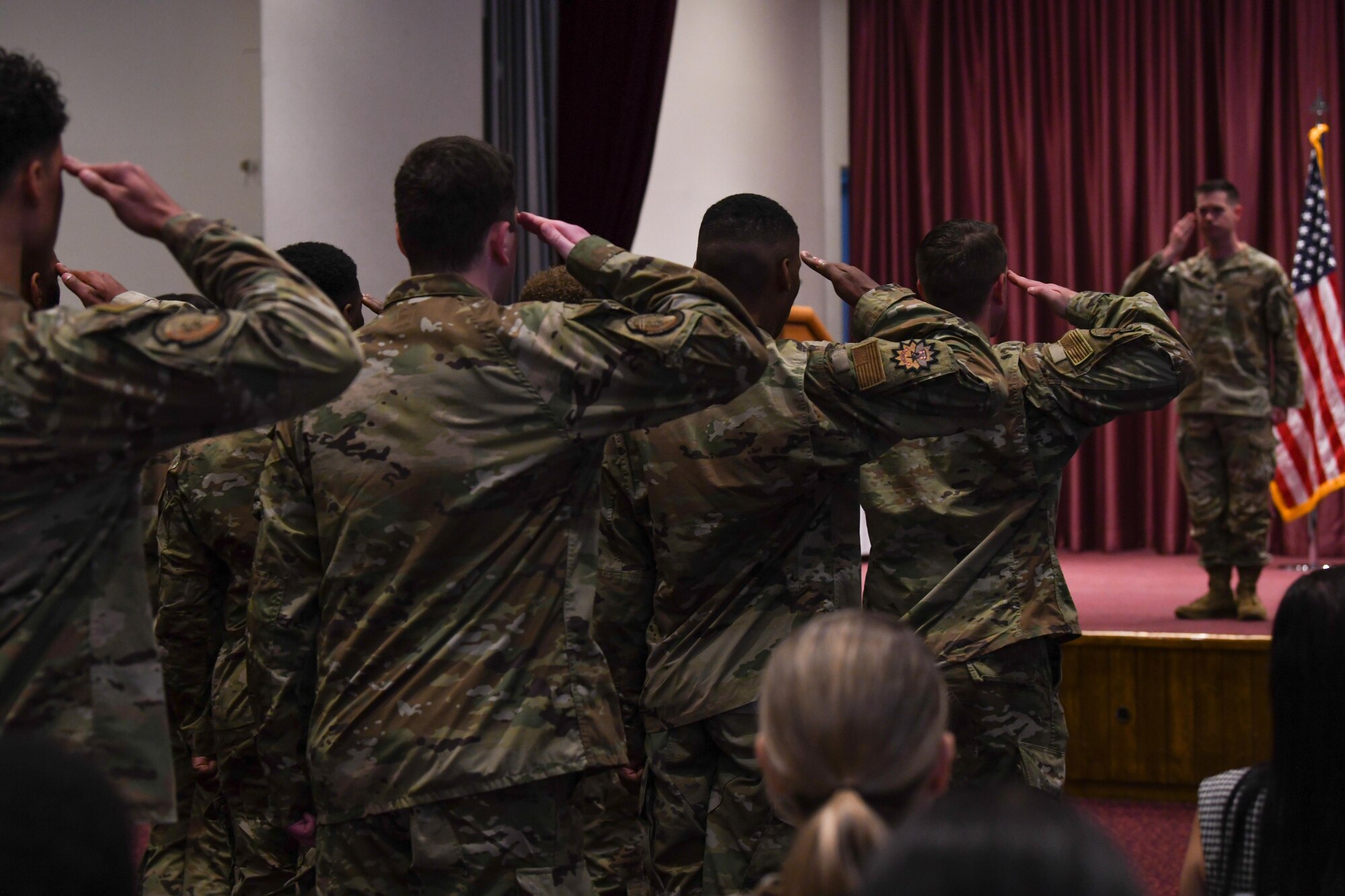 A formation of Airmen salute to the new commander.