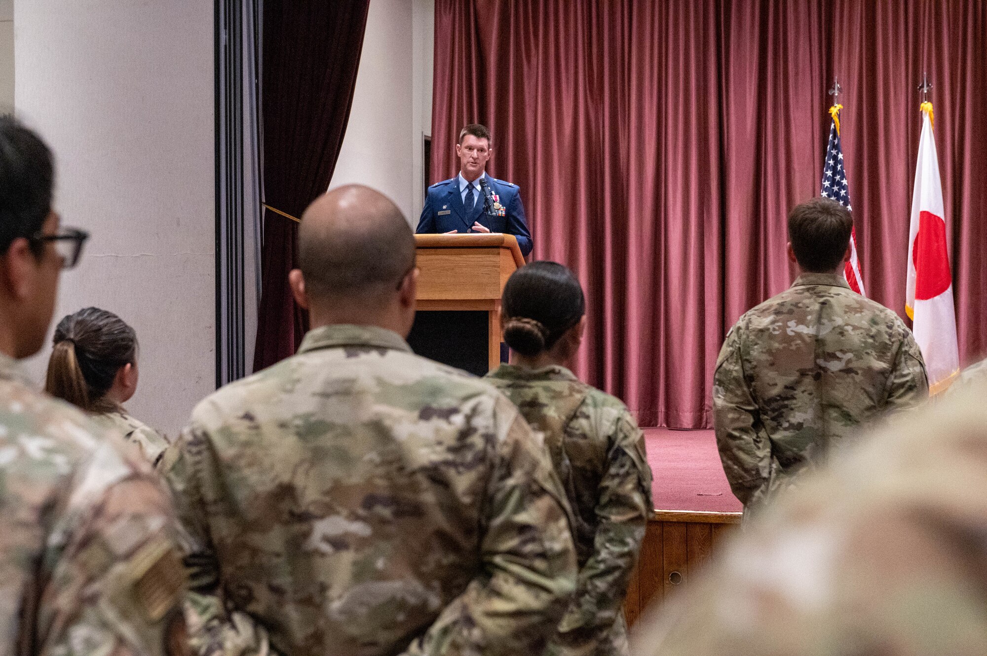 A service member delivers a speech during a change of command ceremony.