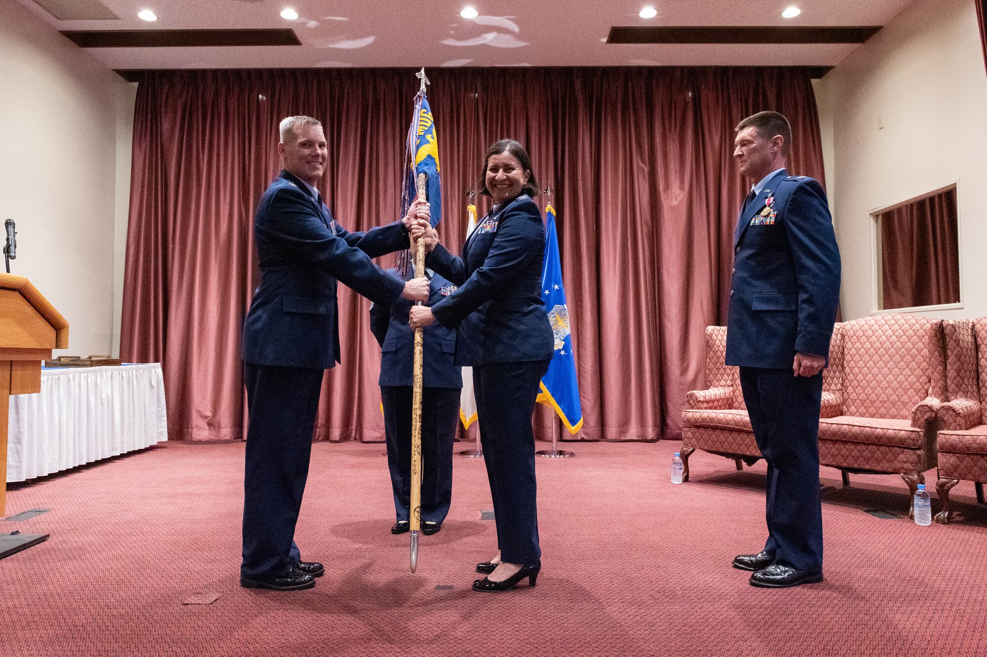 Col. Brad Brough, 374th Medical Group commander, hands a squadron guidon to Col. Iris Ortiz Gonzalez.