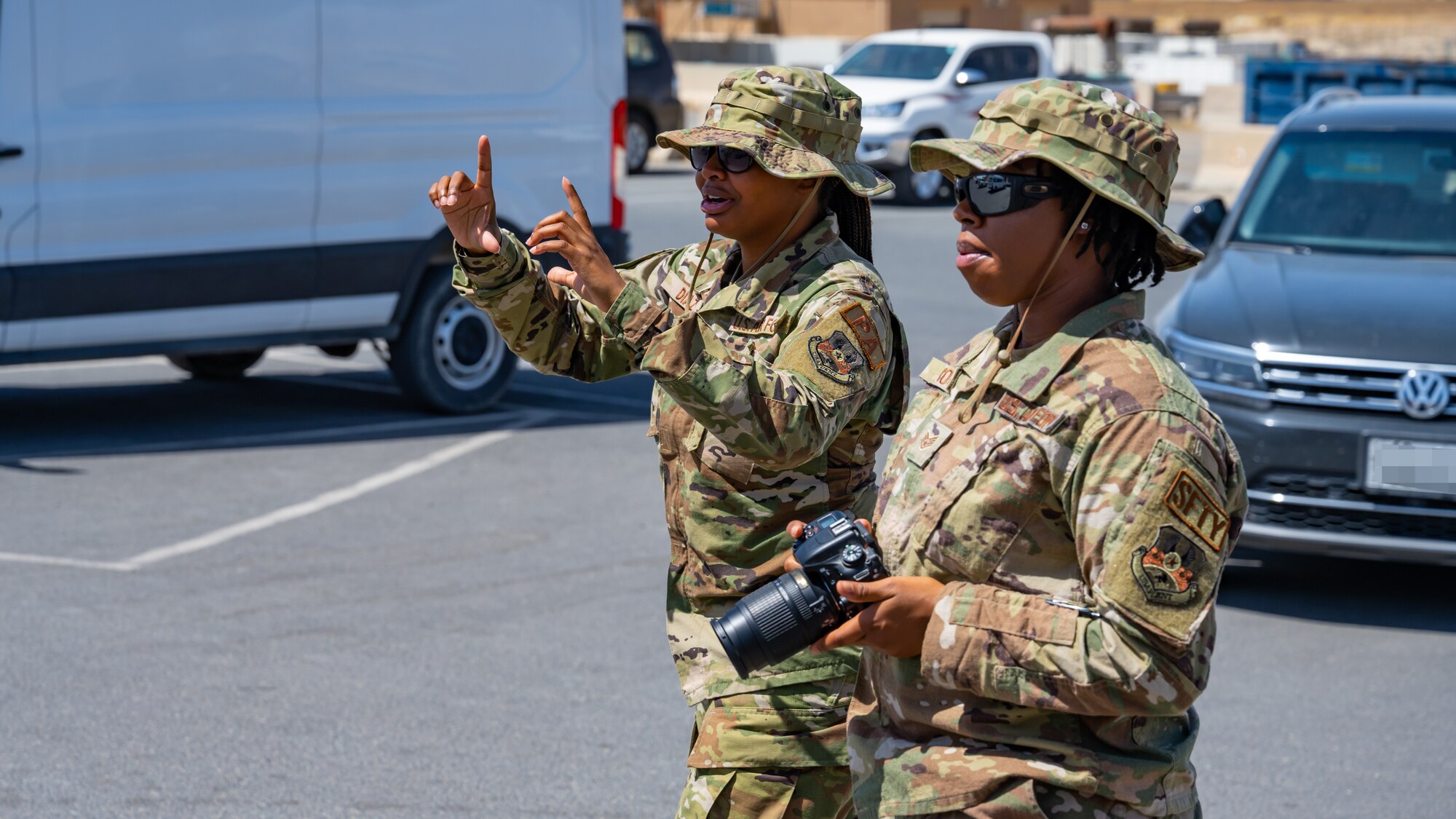 U.S. Air Force Staff Sgt. Breanna Diaz, 386th Air Expeditionary Wing public affairs specialist (left), teaches photo composition techniques to an Airman from the 386th AEW safety office during alert photography training at Ali Al Salem Air Base, Kuwait, June 21, 2023. The 386th AEW safety team attended the training to learn what goes into alert photography, and how it assists with a variety of scenarios and investigations.