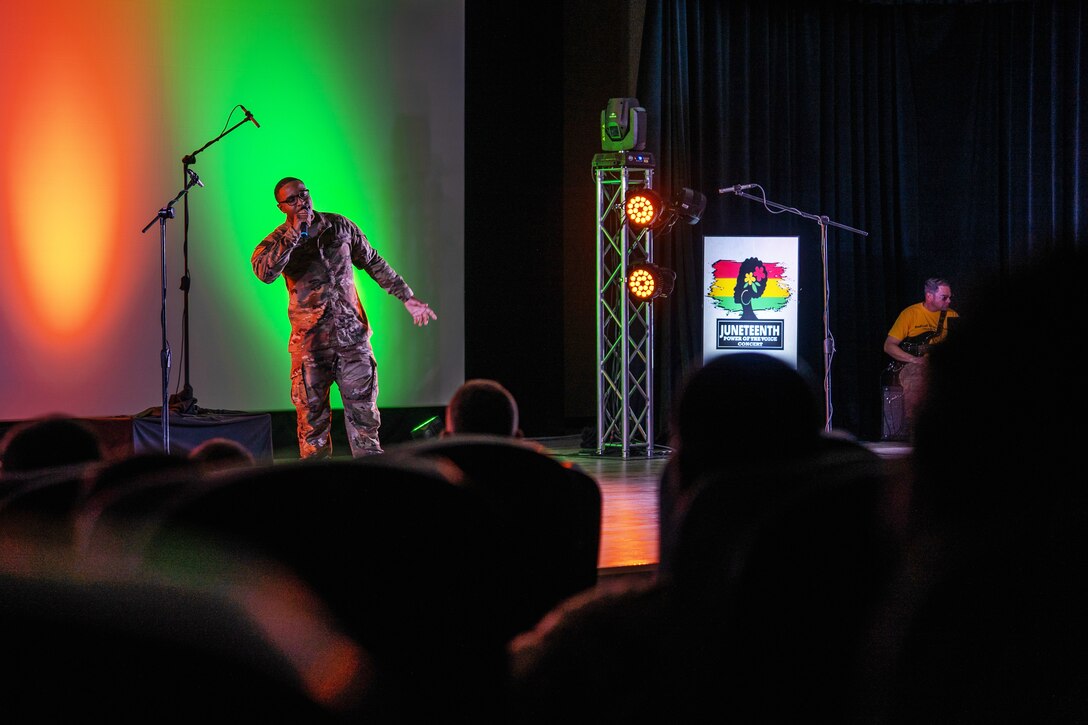 A soldier sings on a stage.