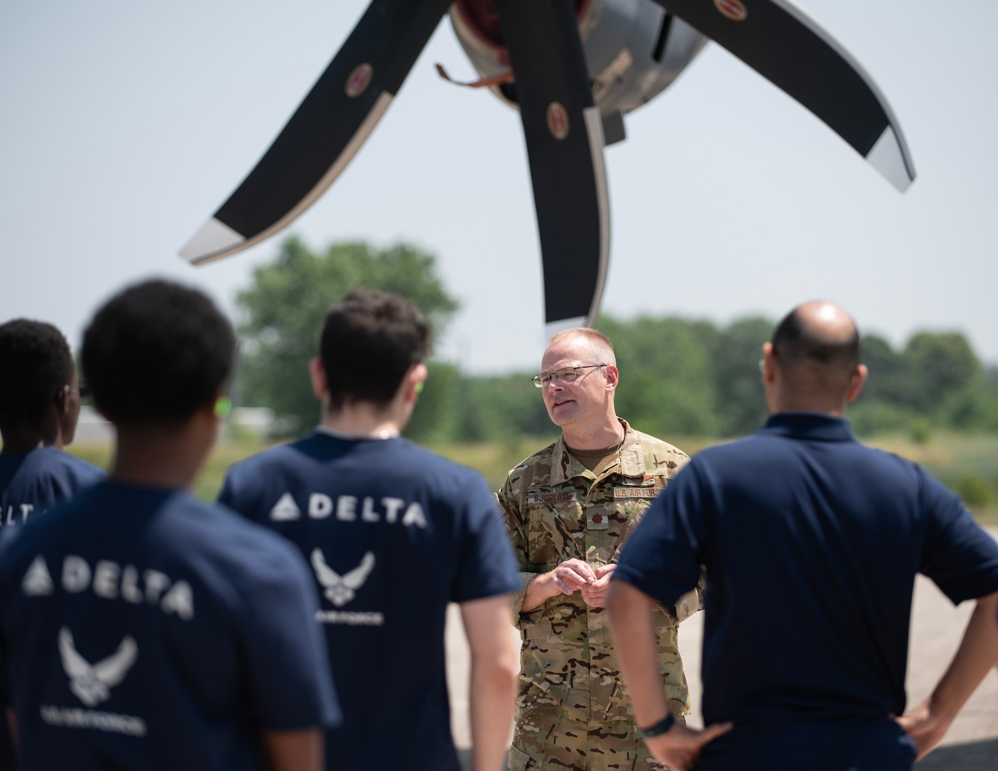 U.S. Air Force Maj. John Sjoblom, 109th Airlift Squadron, answers questions from students of the Organization of Black Aerospace  Professional’s (OBAP) Aviation Career Education (ACE) Academy about the C-130 Hercules in St. Paul, Minn., June 20, 2023.