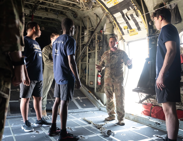 U.S. Air Force Maj. Brennan Coatney, 109th Airlift Squadron, talks about chaining down equipment in a C-130 Hercules in St. Paul, Minn., June 20, 2023.