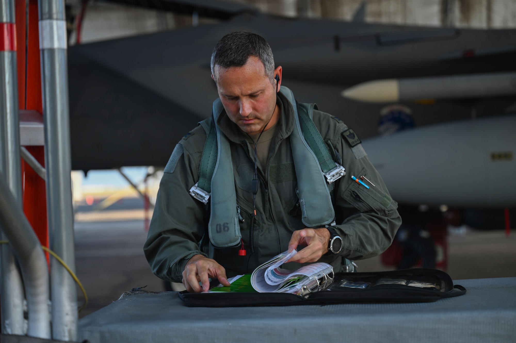 U.S. Air Force Col. John Paul F. Mintz, 850th Spectrum Warfare Group commander, prepares for his final flight, at Eglin Air Force Base, Fla., June 20, 2023.  The final flight, or fini-flight, is a tradition for pilots and some aircrew members who are retiring or moving to another base. Part of the tradition is being hosed with water as soon as they step out of the aircraft after the flight. (U.S. Air Force photo by Staff Sgt. Ericka A. Woolever)