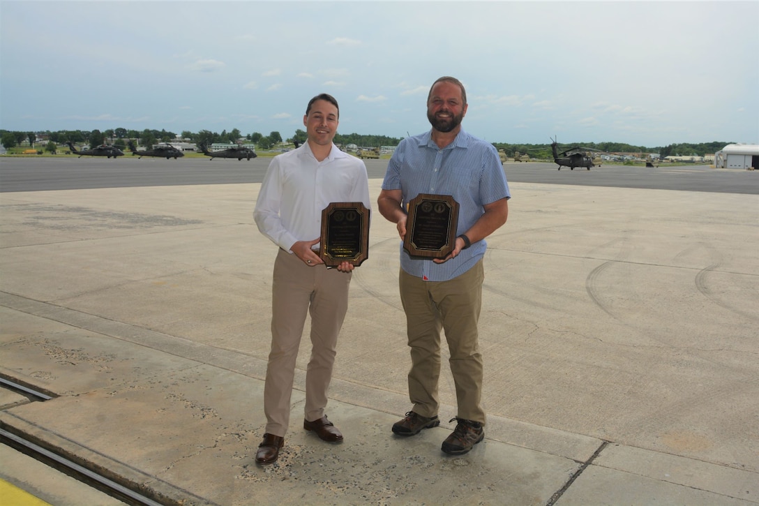 Joshua Dietrich, left, airfield manager at Muir Army Airfield, and Joseph Sandbakken, safety officer at Muir Army Airfield, pose with their awards June 21, 2023, at Muir Army Airfield at Fort Indiantown Gap, Pa. Dietric was named Army National Guard 2022 Airfield Manager of the Year, and Sandbakken was named Army National Guard 2022 Safety Officer of the Year. (Pennsylvania National Guard photo by Brad Rhen)