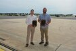 Joshua Dietrich, left, airfield manager at Muir Army Airfield, and Joseph Sandbakken, safety officer at Muir Army Airfield, pose with their awards June 21, 2023, at Muir Army Airfield at Fort Indiantown Gap, Pa. Dietric was named Army National Guard 2022 Airfield Manager of the Year, and Sandbakken was named Army National Guard 2022 Safety Officer of the Year. (Pennsylvania National Guard photo by Brad Rhen)