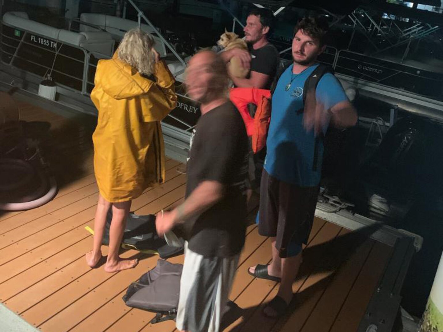 The four rescued people and their dog at Station Fort Myers Beach, June 21, 2023. The people were rescued south of Sanibel Island after their sailboat started taking on water. (U.S. Coast Guard photo by Station Fort Myers Beach)