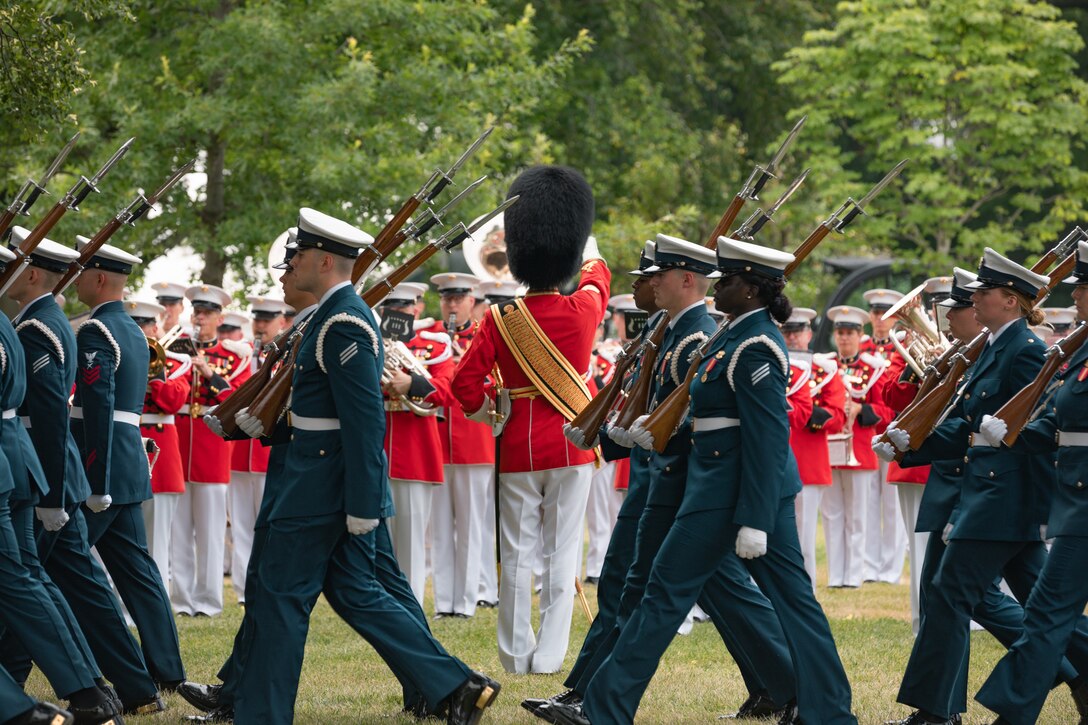 Coast Guardsmen march by the Marine Band as it performs on the South Lawn of the White House on June 20, 2023 during a rehearsal for the State Arrival of Indian Prime Minister Modi.