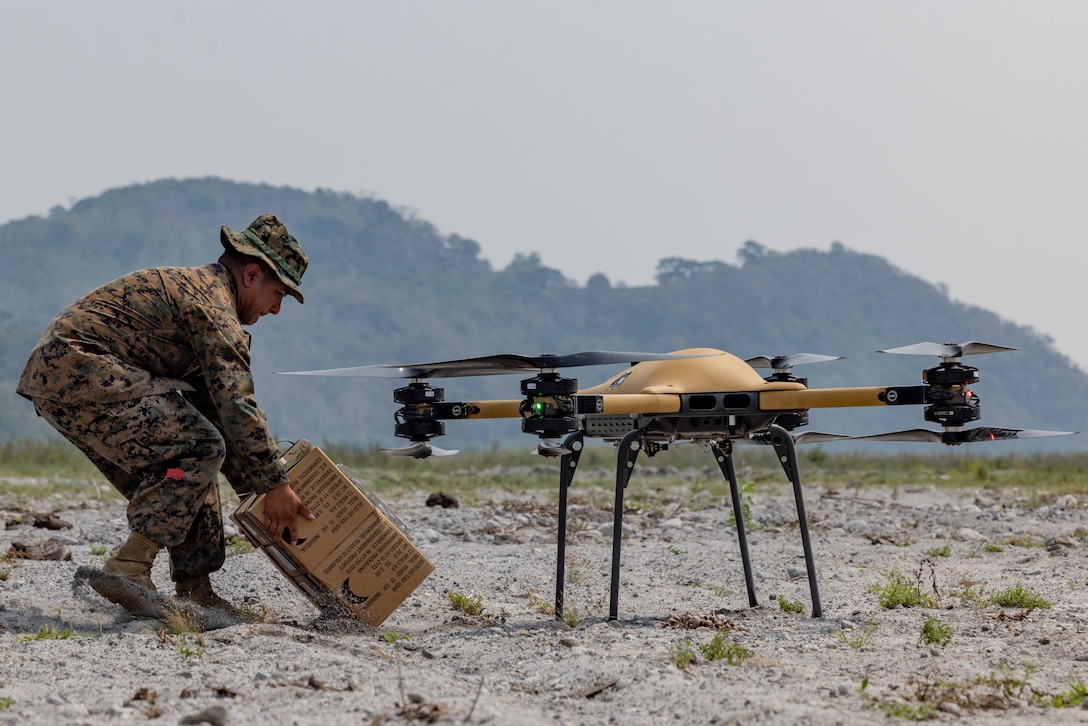 U.S. Marine Corps Cpl. Mark Bernal, a landing support specialist with 3d Littoral Logistics Battalion, 3d Marine Littoral Regiment, 3d Marine Division, receives a package from a TRV-50 Tactical Resupply Unmanned Aircraft System as it lands to resupply U.S. Marines in the field during Balikatan 23 in Cerab, Philippines, April 21, 2023. Balikatan is an annual exercise between the Armed Forces of the Philippines and U.S. military designed to strengthen bilateral interoperability, capabilities, trust, and cooperation built over decades of shared experiences. Bernal is a native of San Antonio, Texas.