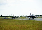 Four U.S. Air Force F-16 Fighting Falcon aircraft,140th Wing, Colorado National Guard, taxi on the runway after arriving from Colorado to participate in exercise Air Defender 2023 at Schleswig-Jagel Air Base, Germany, June 3, 2023. Exercise AD23 integrates both U.S. and allied air-power to defend shared values, while leveraging and strengthening vital partnerships to deter aggression around the world. (Photo by U.S. Air National Guard Capt. Benjamin Yokley)