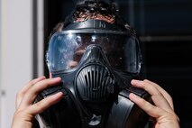 U.S. Air Force Airman 1st Class Kaelon Duke, a 99th Civil Engineer Squadron Emergency Manager, removes his gas mask after chemical, biological, radiological and nuclear (CBRN) training at Nellis Air Force Base, Nevada, June 14, 2023.