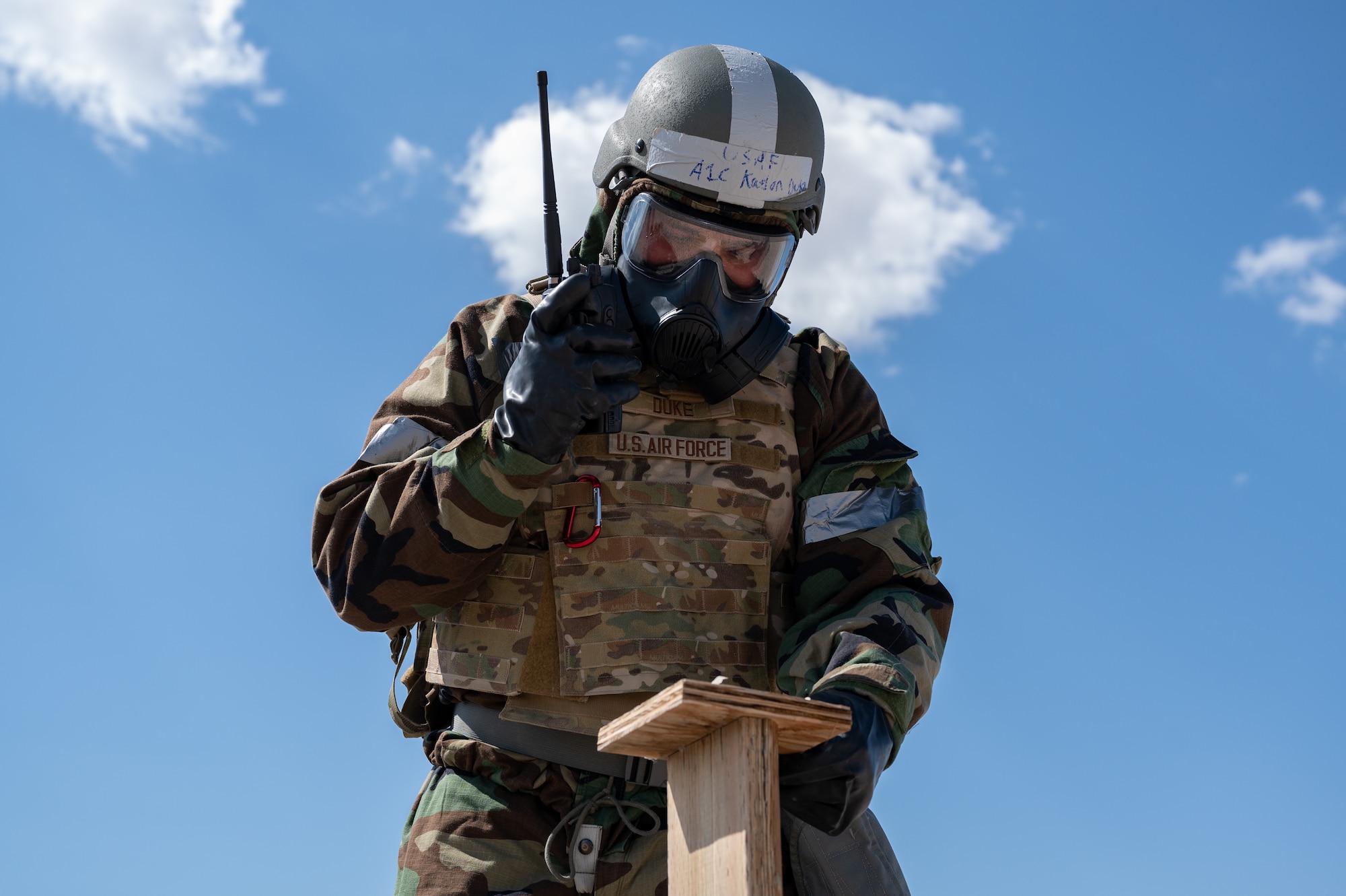U.S. Air Force Airman 1st Class Kaelon Duke, a 99th Civil Engineer Squadron Emergency Manager,  examines M8 paper during chemical, biological, radiological and nuclear training at Nellis Air Force Base, Nevada, June 14, 2023.
