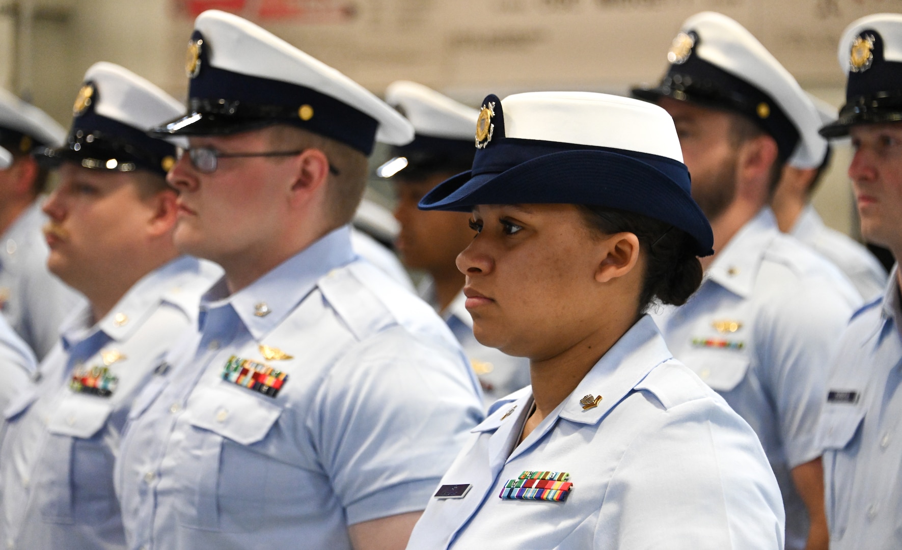 Coast Guard Air Station personnel stand at parade rest during a change-of-command ceremony in Kodiak, Alaska, June 22, 2023. The change-of-command ceremony is a historic Coast Guard and Naval tradition, which has remained unchanged for centuries and includes the reading of the command orders in the presence of all unit crewmembers. U.S. Coast Guard photo by Petty Officer 3rd Class Ian Gray.