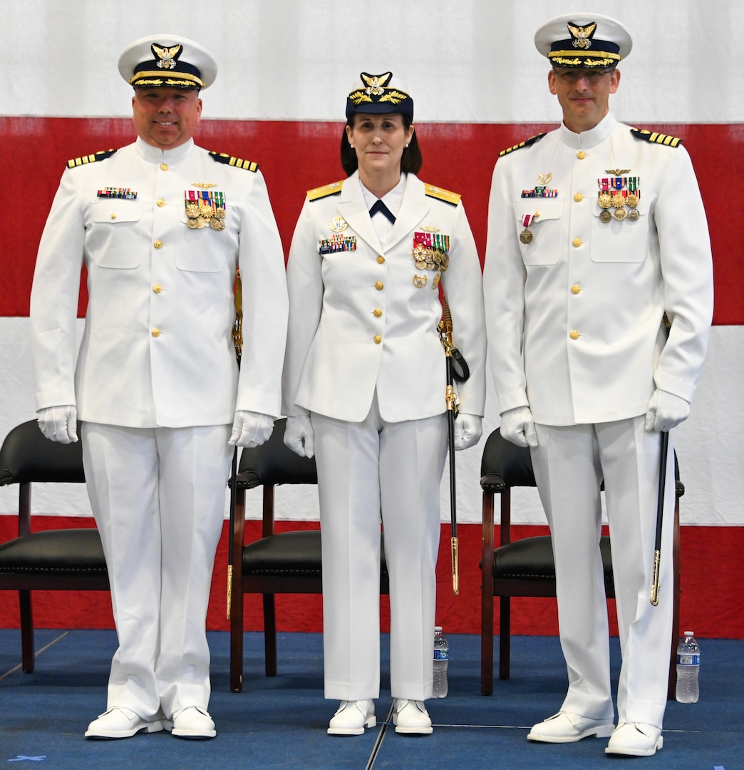 From left, U.S. Coast Guard Capt. Timothy Williams, commanding officer, Air Station Kodiak, Rear Adm. Megan Dean, Seventeenth district commander, and Capt. Nathan Coulter pose for a photo during a change-of-command ceremony at Air Station Kodiak, June 22, 2023. The change-of-command ceremony is a historic Coast Guard and Naval tradition, which has remained unchanged for centuries and includes the reading of the command orders in the presence of all unit crewmembers. U.S. Coast Guard photo by Petty Officer 3rd Class Ian Gray.