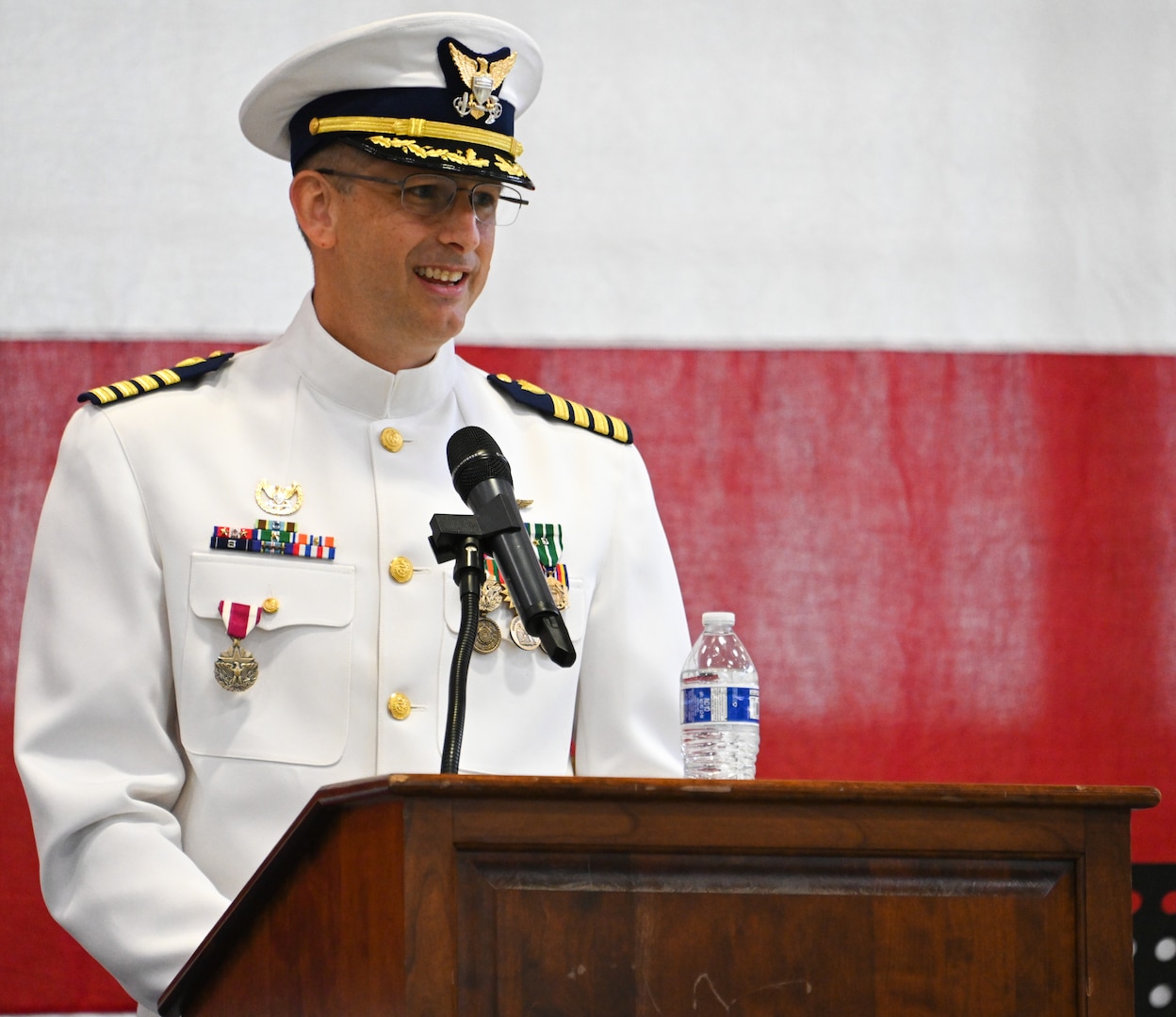 U.S. Coast Guard Capt. Nathan Coulter provides a farewell address to Air Station Kodiak crewmembers during a change-of-command ceremony at the air station, June 22, 2023. Coast Guard Air Station Kodiak was commissioned as an Air Detachment on April 17, 1947 with one coastal aircraft and represented the first permanent Coast Guard aviation resource in Alaska.  U.S. Coast Guard photo by Petty Officer 3rd Class Ian Gray.