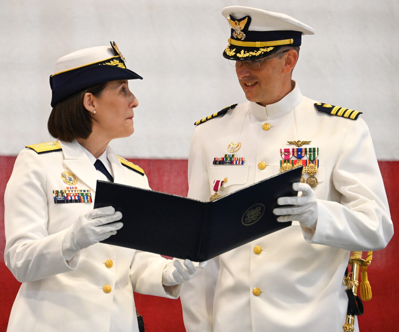 U.S. Coast Guard Rear Adm. Megan Dean, Seventeenth district commander, presents Capt. Nathan Coulter with a certificate of appreciation following Coulter’s retirement ceremony, June 22, 2023. Coulter retired from the Coast Guard after serving 26 years in the service. U.S. Coast Guard photo by Petty Officer 3rd Class Ian Gray.