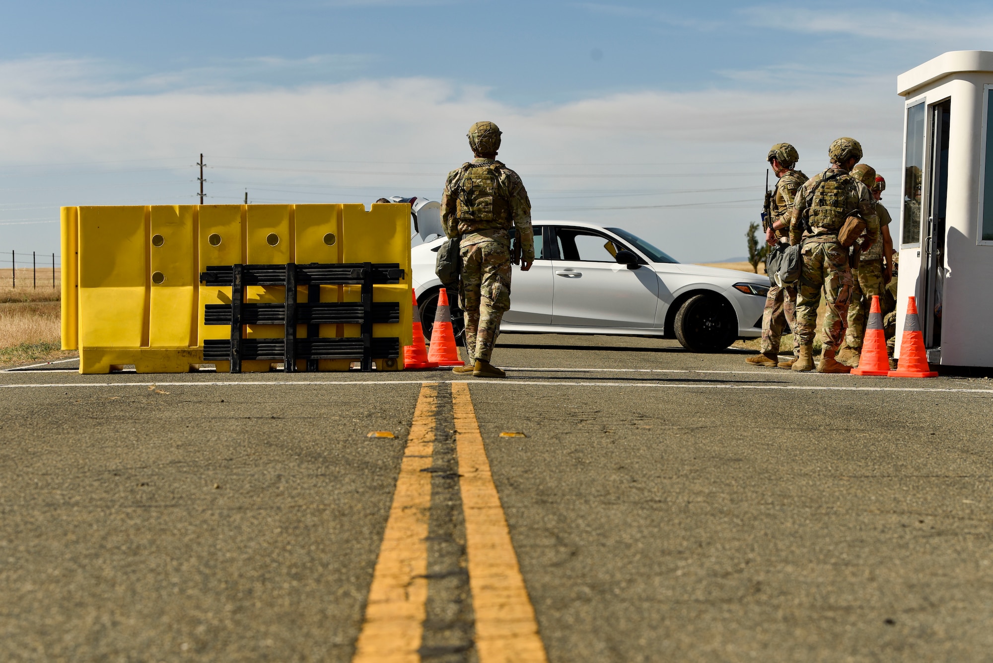 U.S. Air Force 9th Security Forces Squadron defenders monitor an entry control point during Exercise DRAGON FANG, June 15, 2023 at Beale Air Force Base, California.