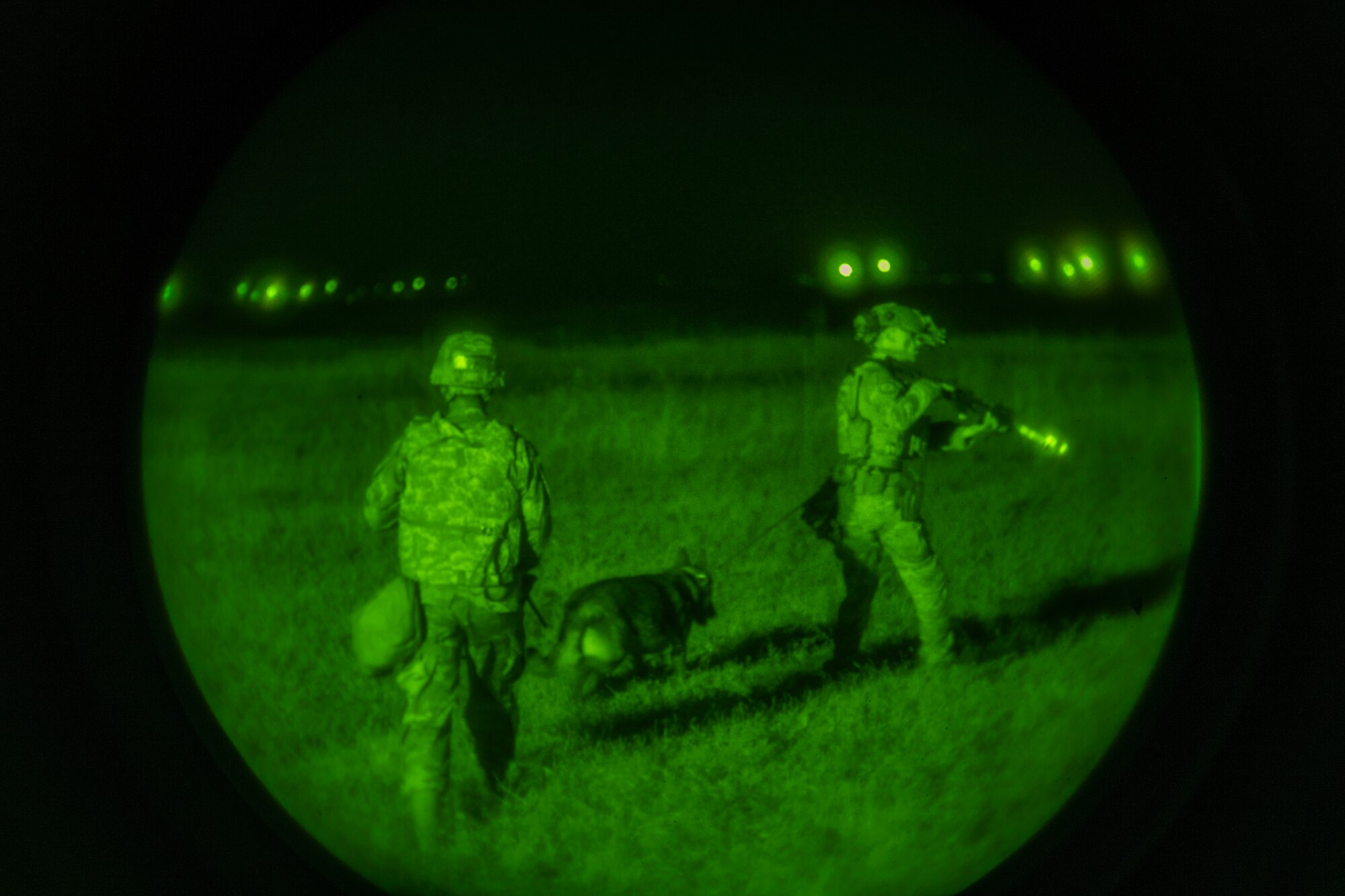 U.S. Air Force 9th Reconnaissance Wing Airmen conduct an area sweep with a K-9 during Exercise DRAGON FANG, June 16, 2023, at Beale Air Force Base, California.