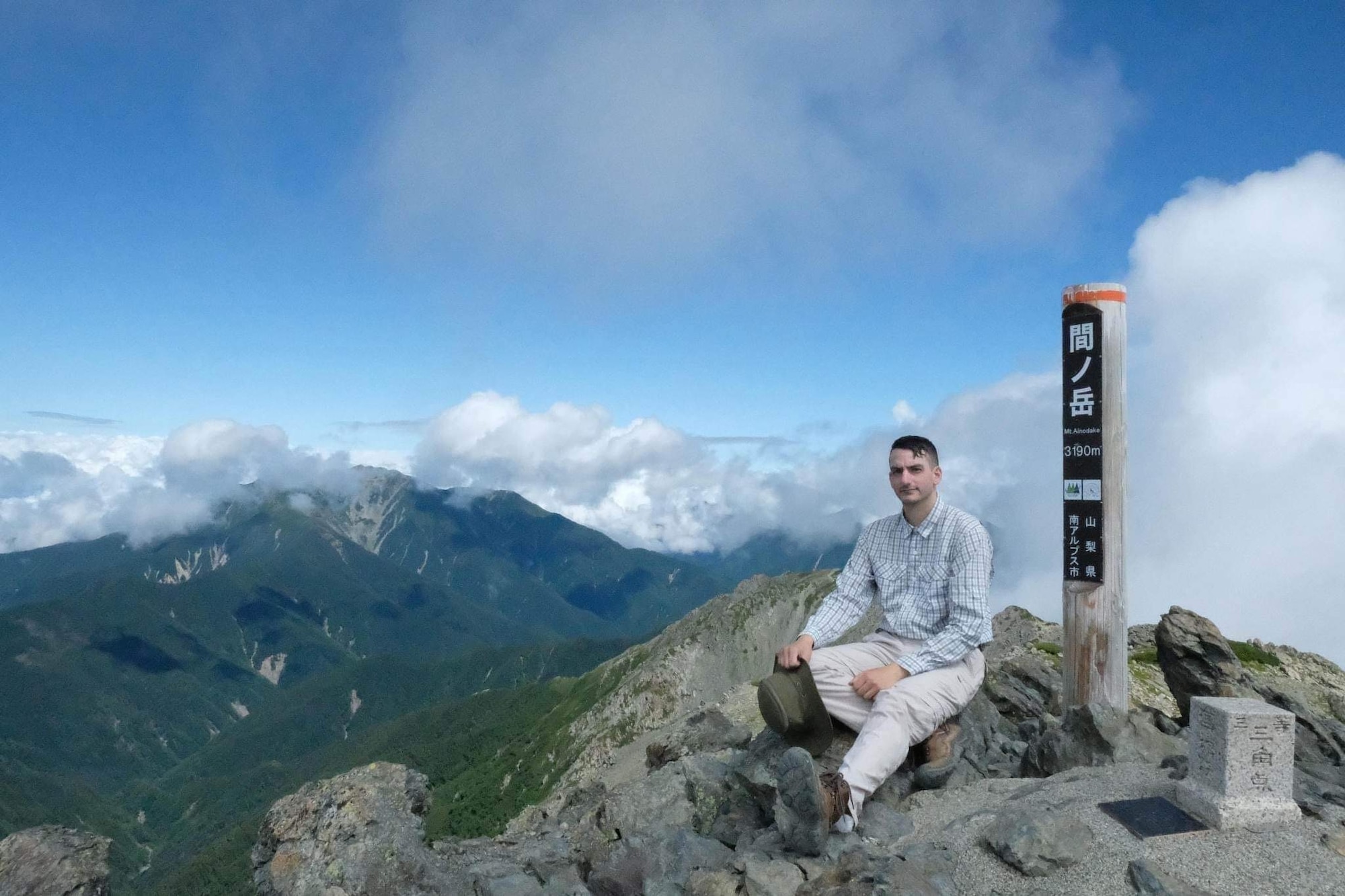 Technical Sergeant Jean-Paul Lucien Trevino sits on a mountain pique.