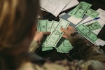 An Airmen from the 139th Comptroller Flight participates in a large readiness exercise at Rosecrans Air National Guard Base, St. Joseph, Mo., June 9, 2023. The finance office handled different financial scenarios to prepare them during the LRE. (U.S. Air National Guard photo by Staff Sgt. Andrew Rivera)