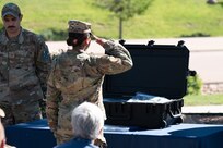 U.S. Air Force Senior Airman Savannah Serda, 50th Force Support Squadron, salutes after putting an Air Force flag in the Team Schriever time capsule next to U.S. Air Force Master Sgt. James Carroll, First Sergeant of Schriever Mission Support Directorate,   on Schriever Space Force Base on June 21, 2023. The flag was the final Air Force flag flown on the base and was placed in the time capsule as a symbolic remembrance of the men and women who served this base. (U.S. Space Force photo by Airman 1st Class Justin Todd)