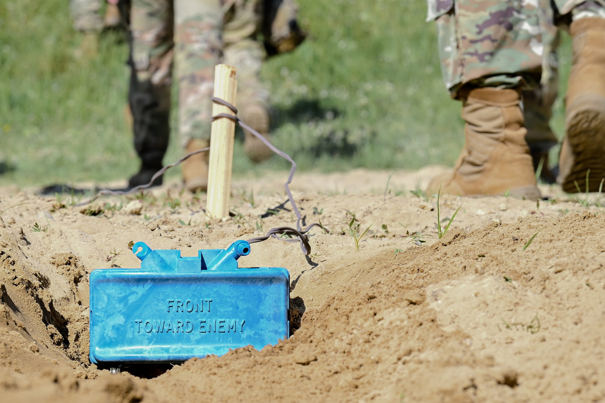 Integrated Defense Leadership Course cadre walk away from a practice claymore placed in the sand on June 1, 2023, at Camp James A. Garfield Joint Military Training Center, Ohio.