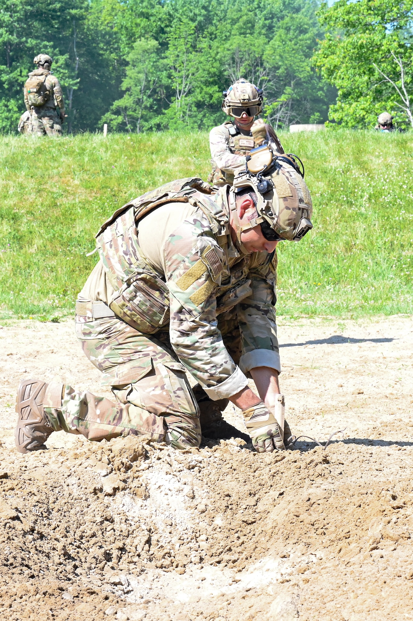 Staff Sgt. Ryan Cisneros, an Integrated Defense Leadership Course cadre assigned to the 310th Security Forces Squadron, Schriever Space Force Base, Colorado, prepares a claymore for detonation on June 1, 2023, at Camp James A. Garfield Joint Military Training Center, Ohio.