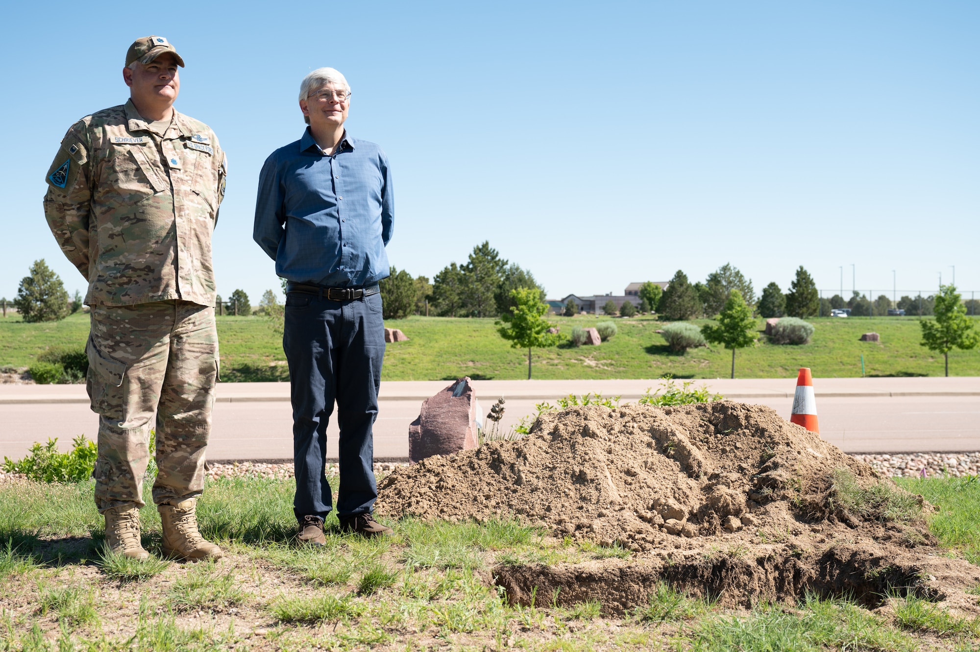 U.S. Space Force Lt. Col. Michael Schriever, Chief of the Engine Room for Space Training and Readiness Command, and Bernard A. Schriever II, a civil engineer at the U.S. Air Force Academy, stand next to the site where the Team Schriever time capsule was buried on Schriever Space Force Base on June 21, 2023. They are both grandsons of the late Gen. Bernard A. Schriever, for whom Schriever SFB was named. (U.S. Space Force photo by Airman 1st Class Justin Todd)