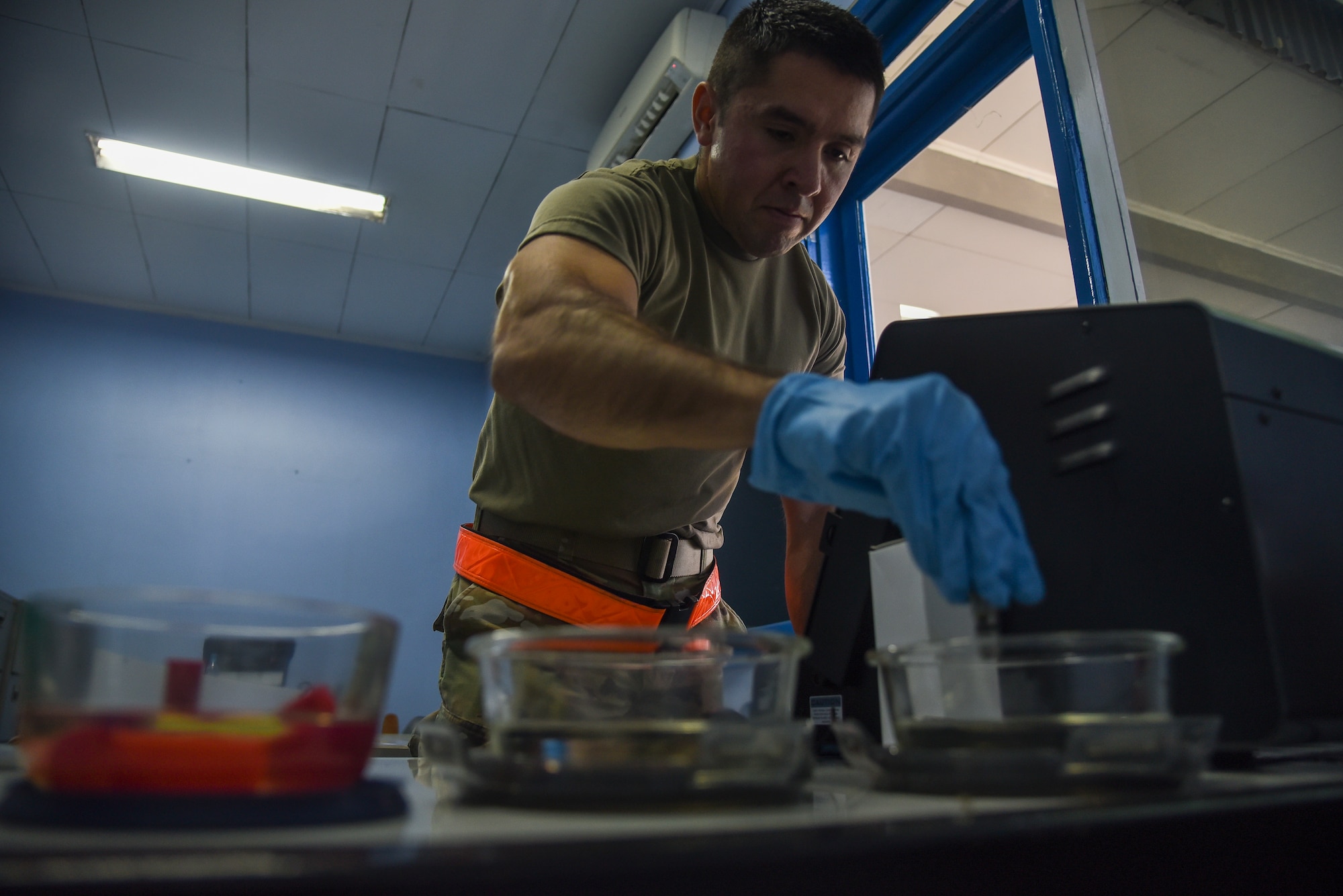 U.S. Air Force Staff Sgt. Daniel Lara, 8th Maintenance Squadron non-destructive inspection craftsman, cleans a magnetic chip detector in an alcohol solution at Roesmin Nurjadin Air Force Base, Indonesia, June 15, 2023. As an NDI craftsman, Lara used a detection machine to ensure foreign materials have not found their way into the engine oil of the F-16s being flown at Cope West 23 as a way of preventative maintenance. (U.S. Air Force photo by Tech. Sgt. Timothy Moore)