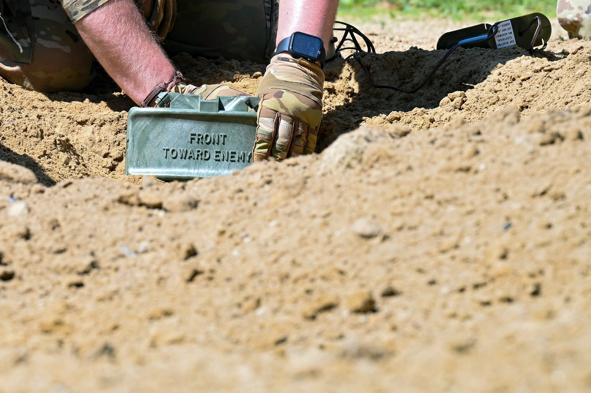 Staff Sgt. Brandon Wilkins, an Integrated Defense Leadership Course cadre member assigned to the 910th Security Forces Squadron, Youngstown Air Reserve Station, Ohio, prepares a claymore for detonation on June 1, 2023, at Camp James A. Garfield Joint Military Training Center, Ohio.