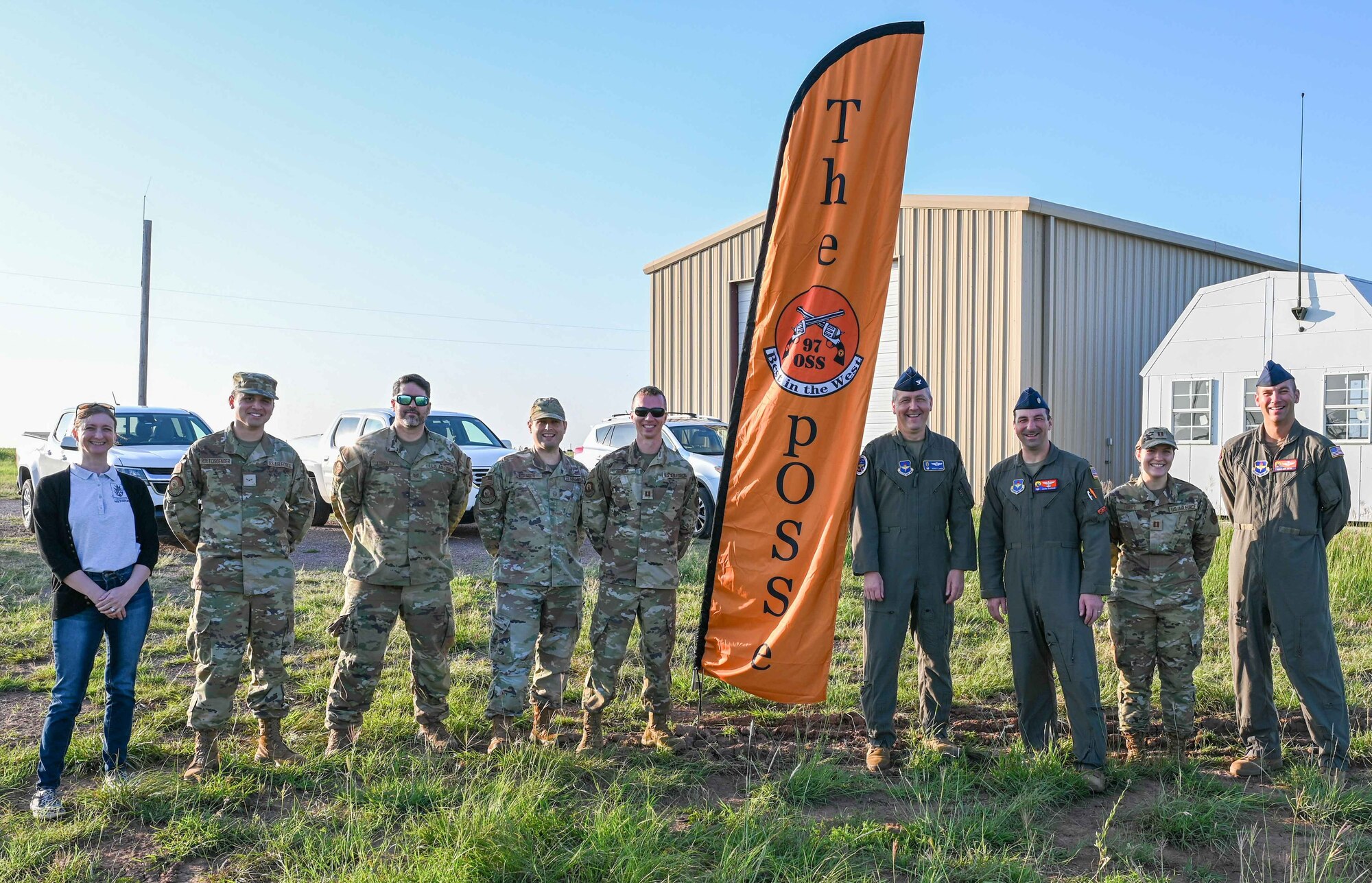 Airmen from the 97th Air Mobility Wing pose for a photo following the first launch of a high-altitude weather balloon at the Sooner Drop Zone, June 15, 2023. The launch was part of a new weather balloon program at Altus Air Force Base, Oklahoma. (U.S. Air Force photo by Airman 1st Class Heidi Bucins)