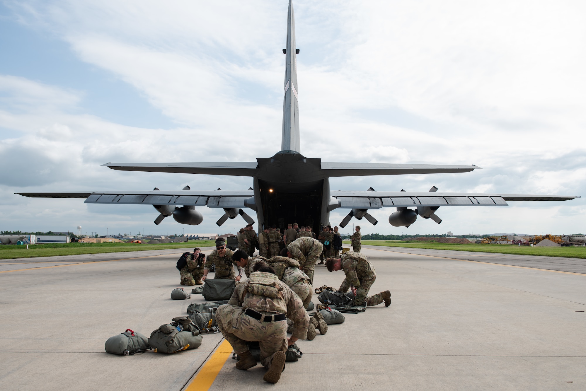 U.S. Air Force 824th Base Defense Squadron Airmen pack gear in preparation for a drop out of a 910th Airlift Wing C-130 Hercules, June 13, 2023, at Tinker Air Force Base, Oklahoma. The BDS drop exercised security forces and 7th Air Support Operations Squadron (ASOS) Tactical Air Control Party (TACP) ability to remain agile in changing conditions in support of Exercise AGILE BLIZZARD-UNIFIED VISION. (U.S. Air Force photo by 1st Lt. Hailey Malay)