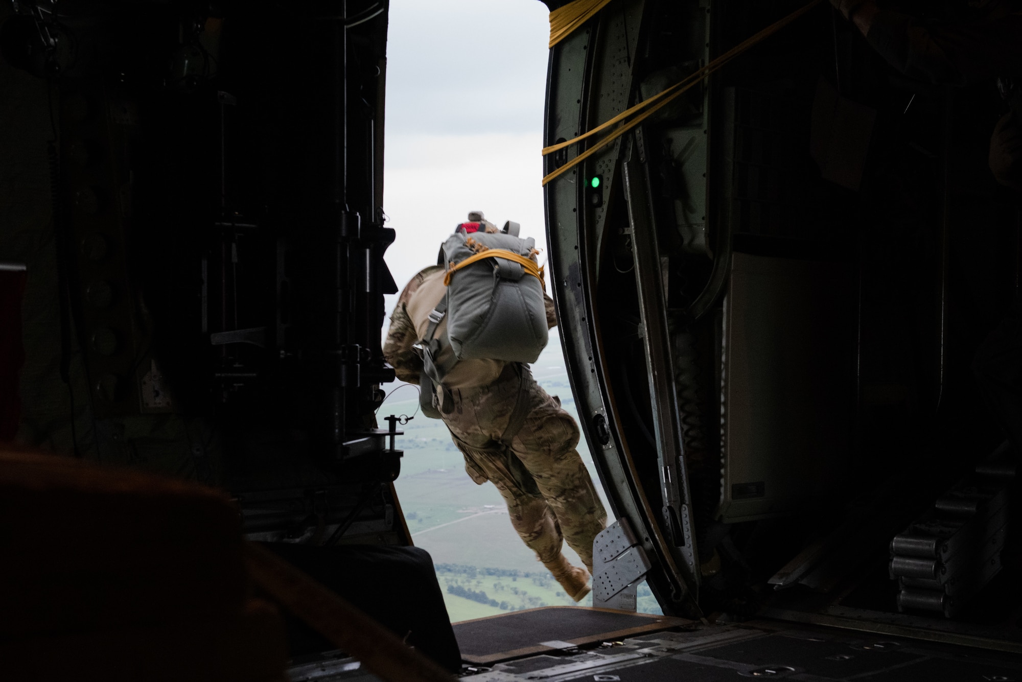 U.S. Air Force Staff Sgt. Dakota Lesak, 824th Base Defense Squadron jump safety lead, drops out of a 910th Airlift Wing C-130 Hercules, June 13, 2023, at Clinton Sherman Airport, Oklahoma. Lesak ensured the other eight 824th BDS members dropped safely, then he followed to support in securing the airfield in support of Exercise AGILE BLIZZARD-UNIFIED VISION. (U.S. Air Force photo by 1st Lt. Hailey Malay)