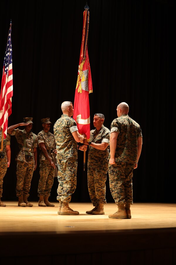 U.S. Marine Corps Brig. Gen. Andrew M. Niebel, left, the outgoing commanding general of Marine Corps Installations East-Marine Corps Base Camp Lejeune (MCIEAST-MCB), transfers the company guidon to the incoming commander, Col. Adolfo Garcia Jr., during the MCIEAST change of command ceremony ​on MCB Camp Lejeune, North Carolina, June 22, 2023. Niebel served as the 8th commanding general of MCIEAST since June 2021 and relinquished his command to Garcia Jr.