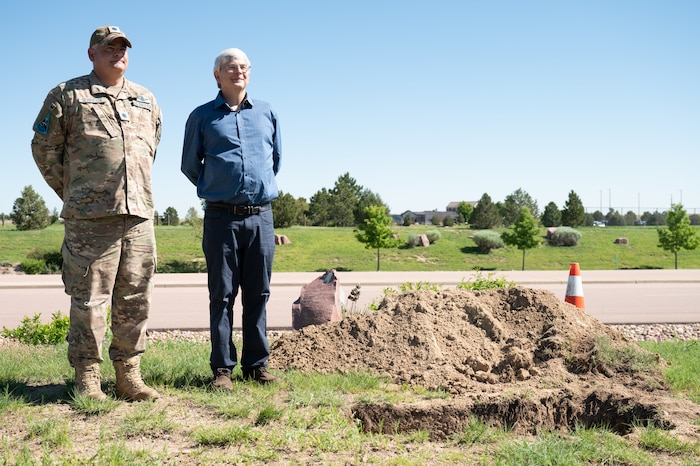 U.S. Space Force Lt. Col. Michael Schriever, Chief of the Engine Room for Space Training and Readiness Command, and Bernard A. Schriever II, a civil engineer at the U.S. Air Force Academy, stand next to the site where the Team Schriever time capsule was buried on Schriever Space Force Base on June 21, 2023. They are both grandsons of the late Gen. Bernard A. Schriever, for whom Schriever SFB was named. (U.S. Space Force photo by Airman 1st Class Justin Todd)
