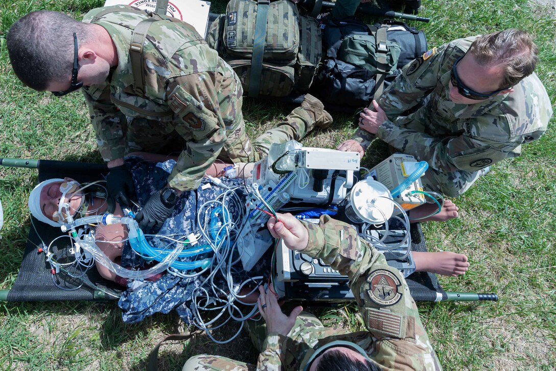 U.S. and foreign medical personnel simulate treatment during an exercise.