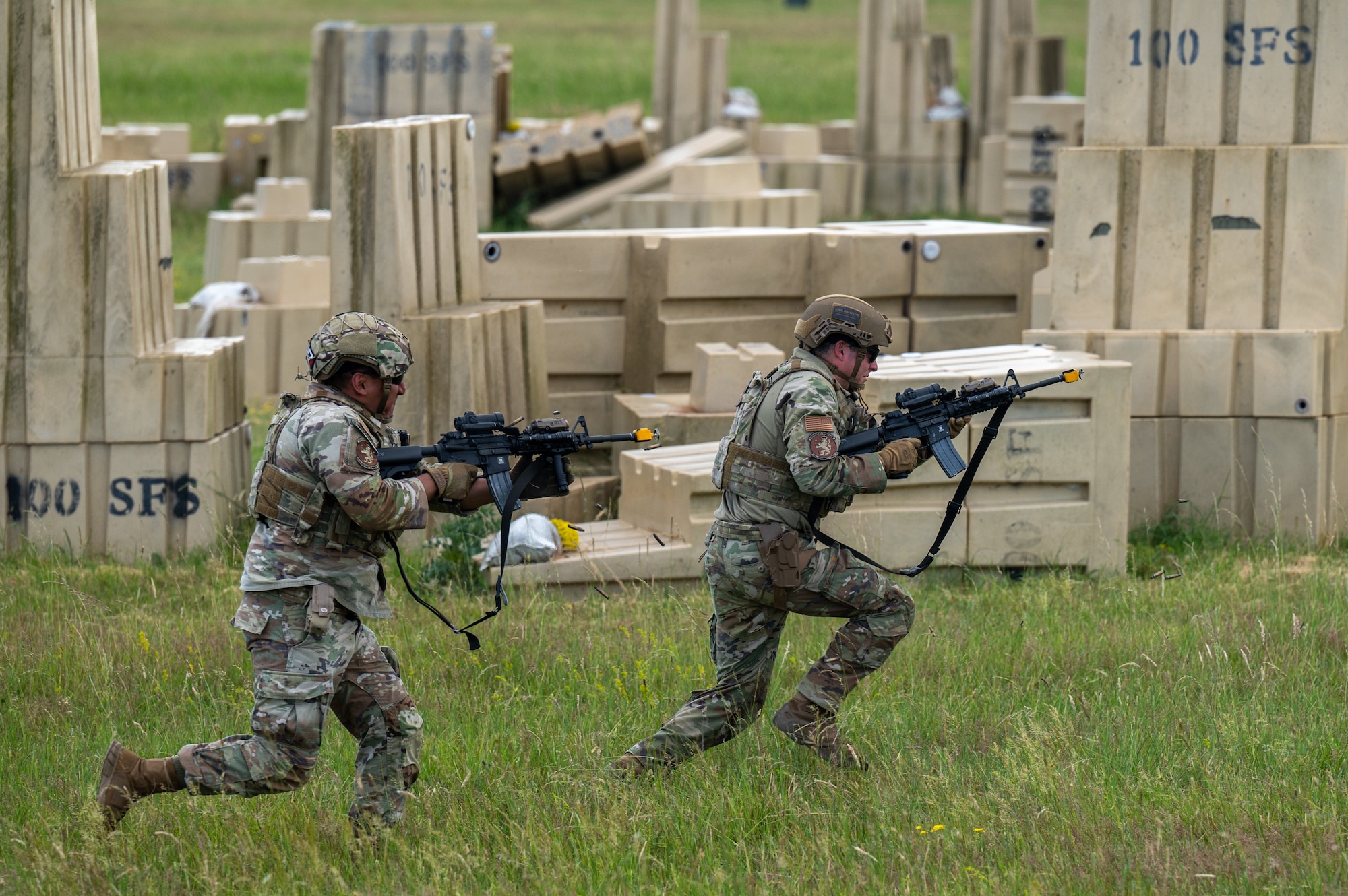 U.S. Air Force Airmen assigned to the 100th Security Forces Squadron, sprint and fire blank ammunition toward a simulated adversary at Royal Air Force Mildenhall, England, June 21, 2023.