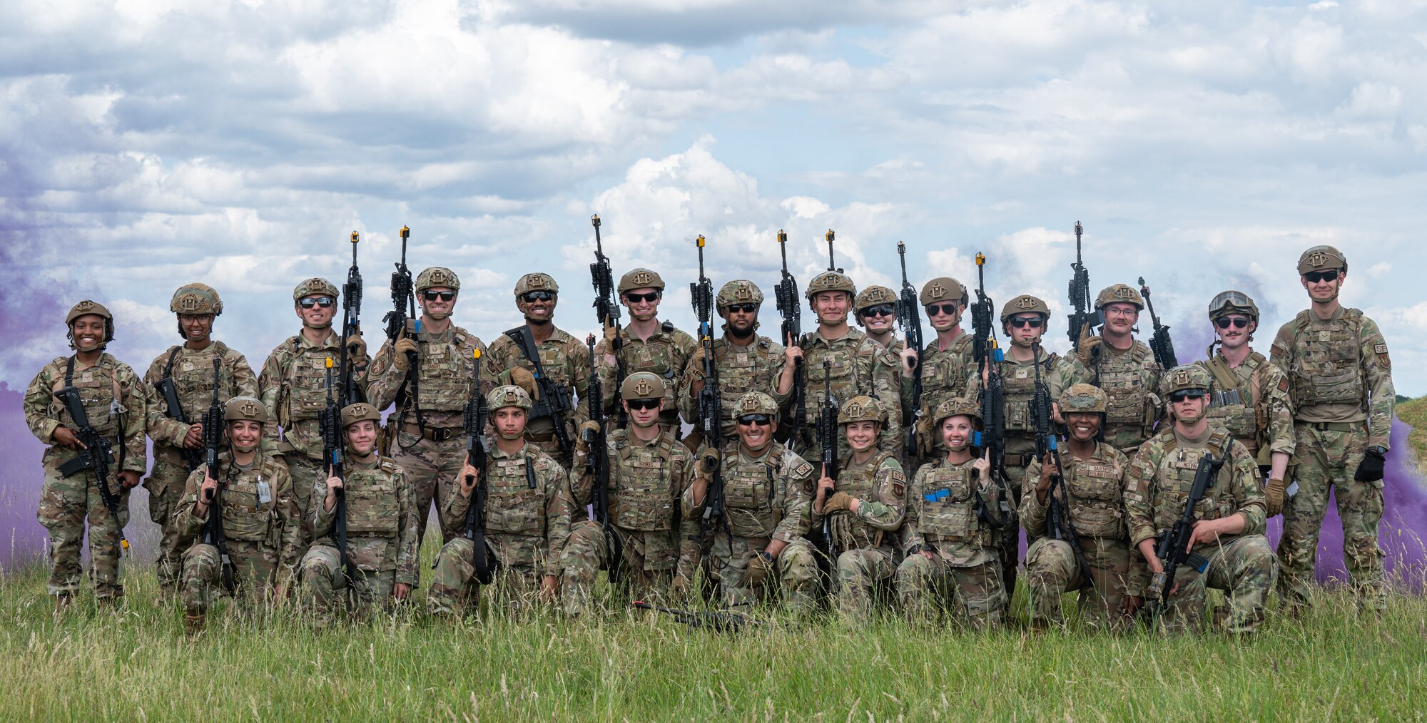 U.S. Air Force Airmen assigned to the 100th Security Forces Squadron, stand together following the end of small unit tactics training at Royal Air Force Mildenhall, England, June 21, 2023.