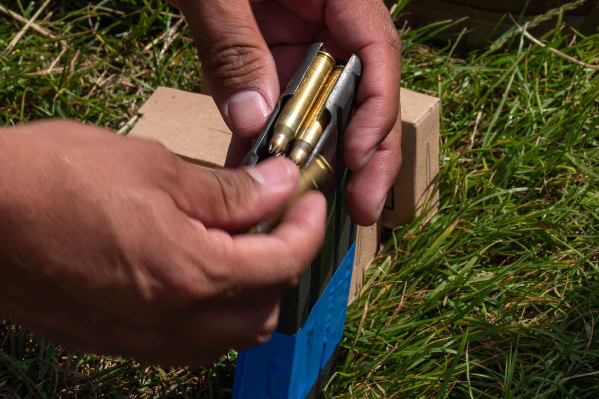 A U.S. Air Force Airman assigned to the 100th Security Forces Squadron, loads blank ammunition into a magazine during a training exercise at Royal Air Force Mildenhall, England, June 21, 2023.