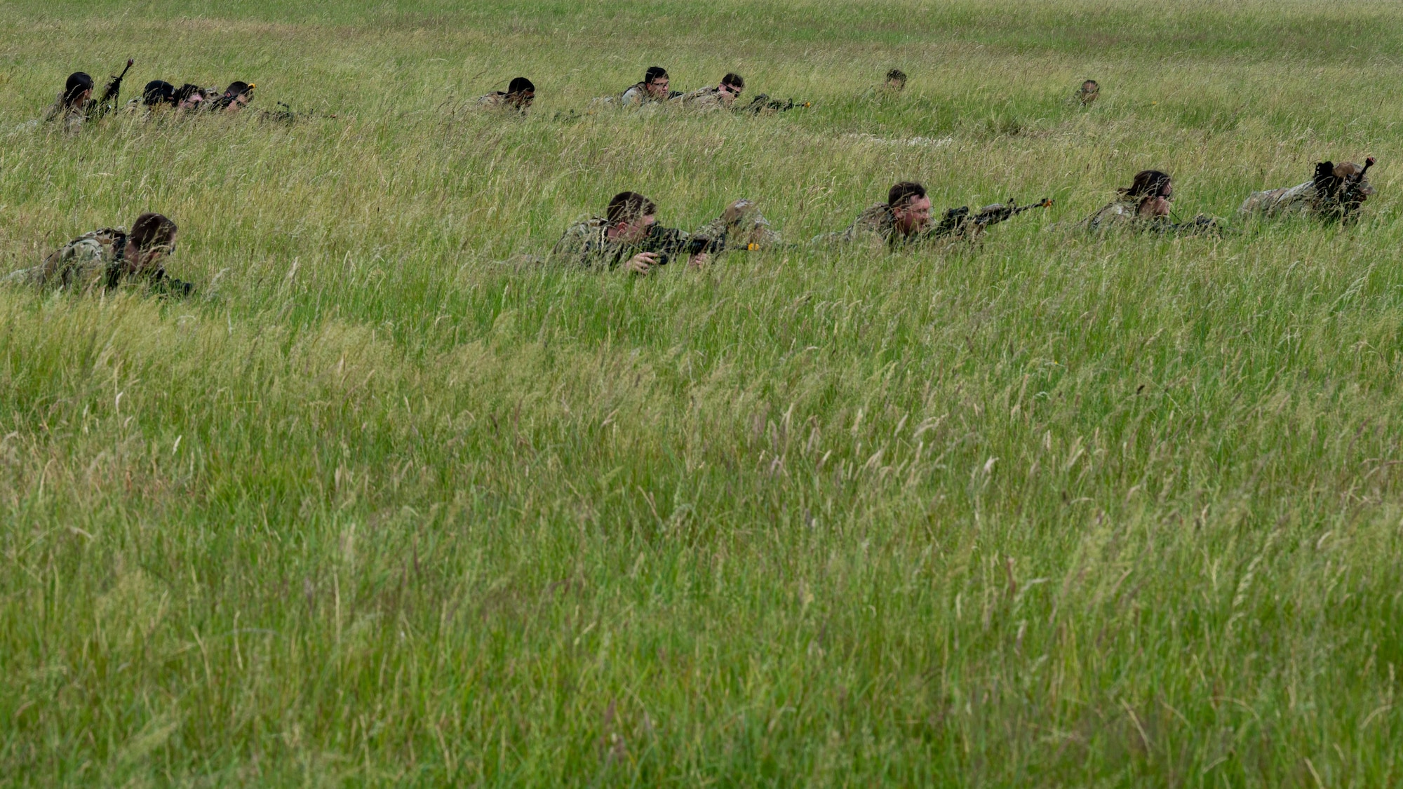U.S. Air Force Airmen assigned to the 100th Security Forces Squadron, lay prone in a simulated austere environment during a training exercise at Royal Air Force Mildenhall, England, June 21, 2023.