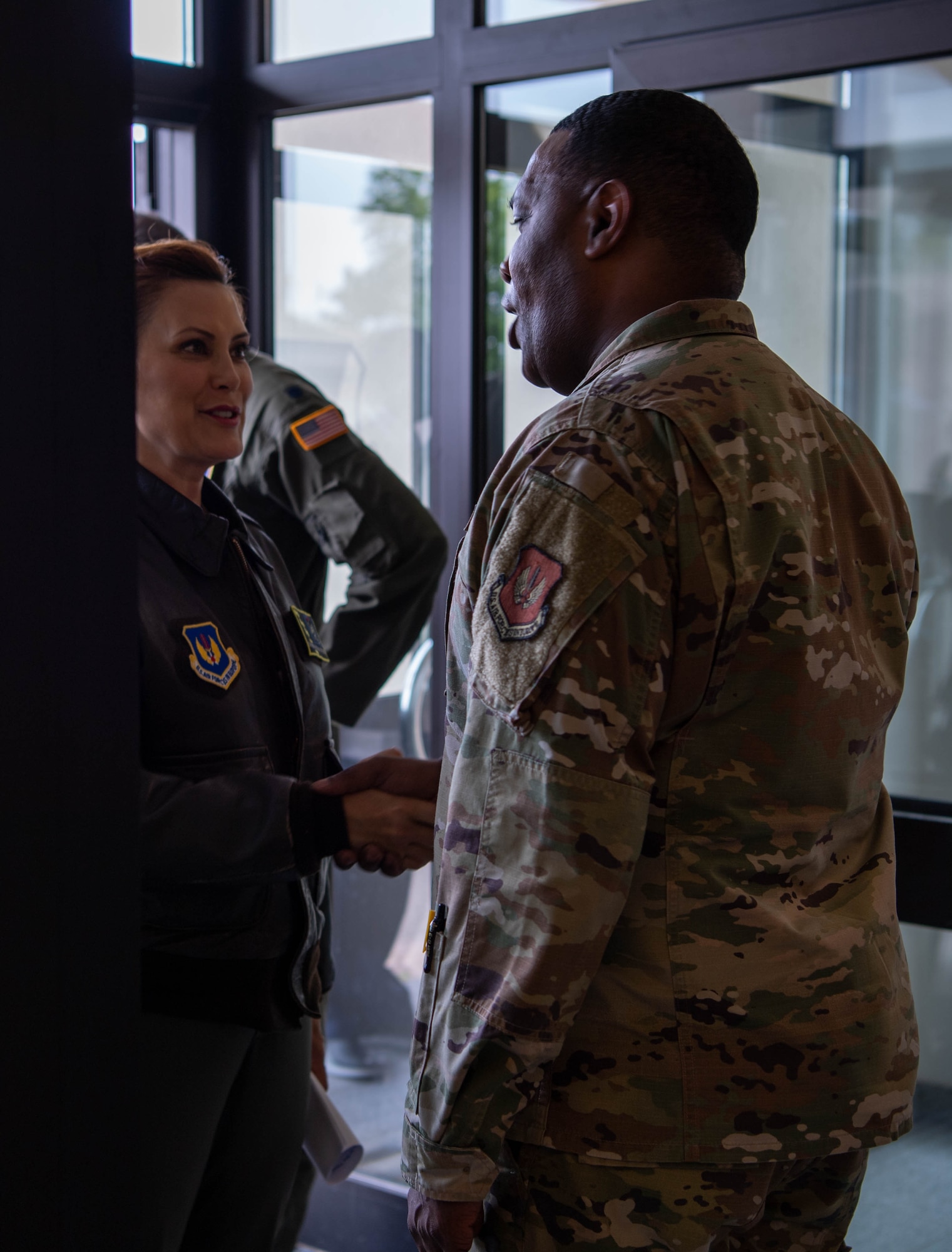 U.S. Air Force Brig. Gen. Ottis C. Jones, 86th Airlift Wing commander, right, greets Michigan Gov. Gretchen Whitmer, left, during her tour of the 86th Headquarters building at Ramstein Air Base, Germany, June 22, 2023.