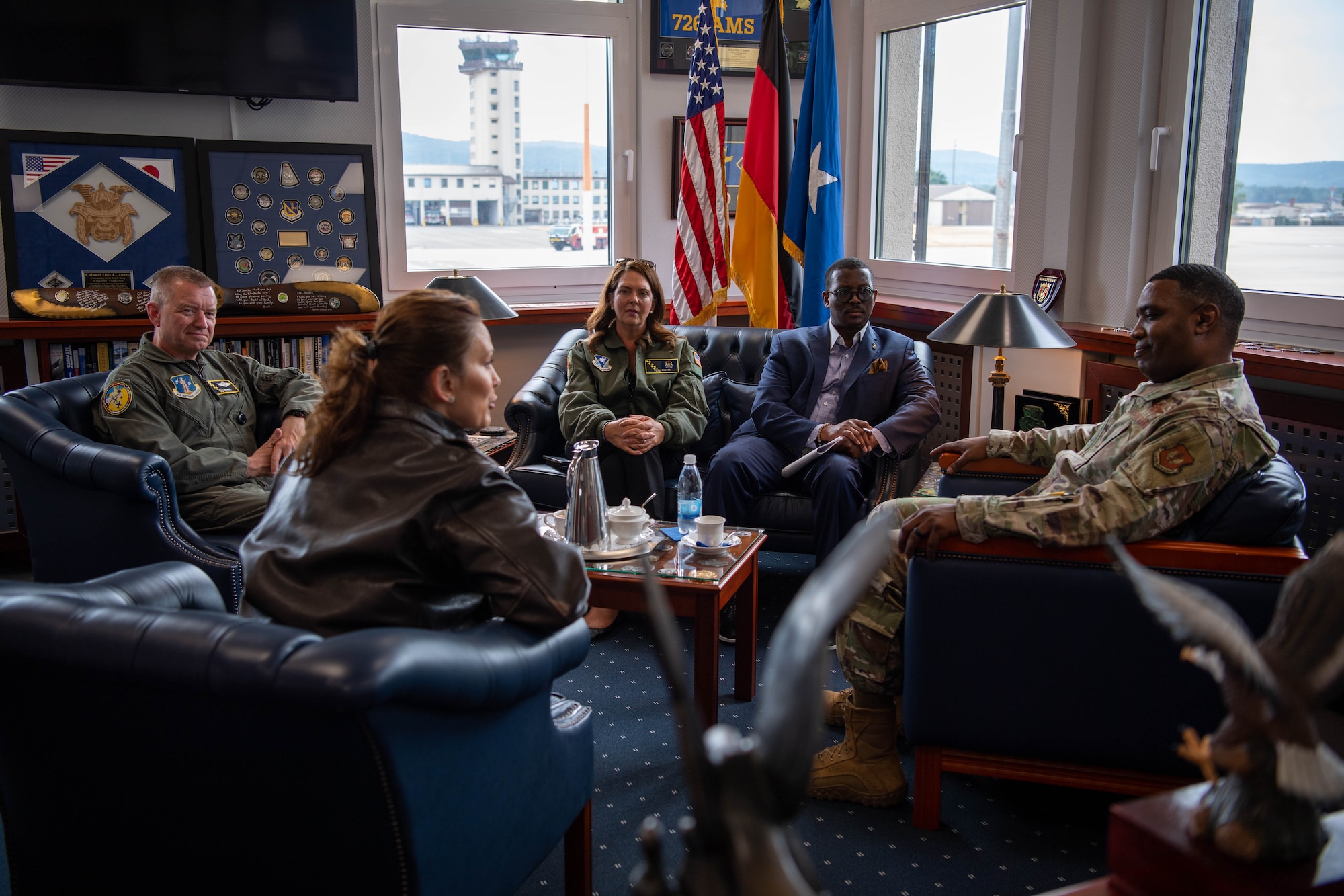 U.S. Air Force Brig. Gen. Ottis C. Jones, 86th Airlift Wing commander, front right, speaks with Michigan Gov. Gretchen Whitmer, front left, Brig. Gen. Rolf Mammen, 127th Wing Commander of Selfridge Air National Guard Base, Michigan, back left, Triscia Foster, Executive Office of the Governor chief operating officer, back middle, and Quentin Messer Jr., Michigan Economic Development Corporation chief executive officer, back right, at Ramstein Air Base, Germany, June 22, 2023.