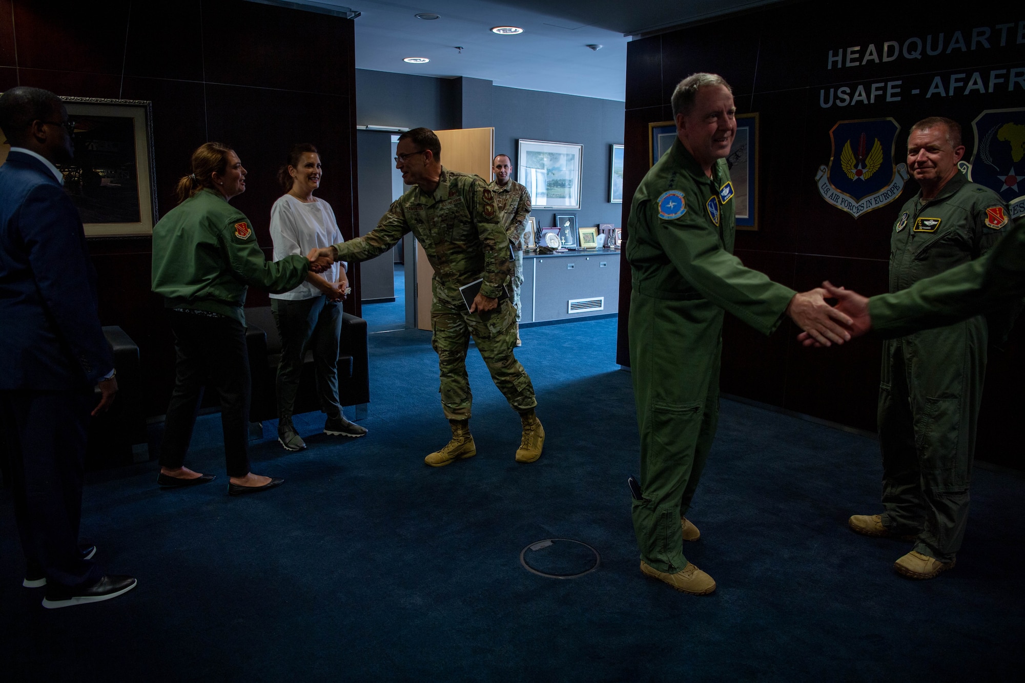 U.S. Air Force Gen. James B. Hecker, U.S. Air Forces in Europe and Air Forces Africa commander, front right, greets Michigan Gov. Gretchen Whitmer, back left, and her team during their tour at Ramstein Air Base, Germany, June 22, 2023.