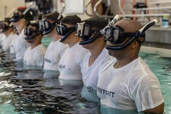 Sailors assigned to Naval Aviation Schools Command (NASC) stand in formation during the Aviation Rescue Swimmer School Preparatory Course in Pensacola, Florida, June 21, 2023. NASC is one of the more than 1,640 subordinate learning sites that serve as a part of the Naval Education and Training Command (NETC) domain. NETC's mission is to recruit, train and deliver those who serve our nation, taking them from street-to-fleet by forging civilians into highly skilled, operational and combat ready warfighters. (United States Navy photo by Mass Communication Specialist 1st Class Zachary Melvin)