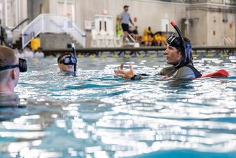 Steve Ballard, right, a contractor assigned to Naval Aviation Schools Command (NASC), instructs Sailors during the Aviation Rescue Swimmer School Preparatory Course in Pensacola, Florida, June 21, 2023. NASC is one of the more than 1,640 subordinate learning sites that serve as a part of the Naval Education and Training Command (NETC) domain. NETC's mission is to recruit, train and deliver those who serve our nation, taking them from street-to-fleet by forging civilians into highly skilled, operational and combat ready warfighters. (United States Navy photo by Mass Communication Specialist 1st Class Zachary Melvin)