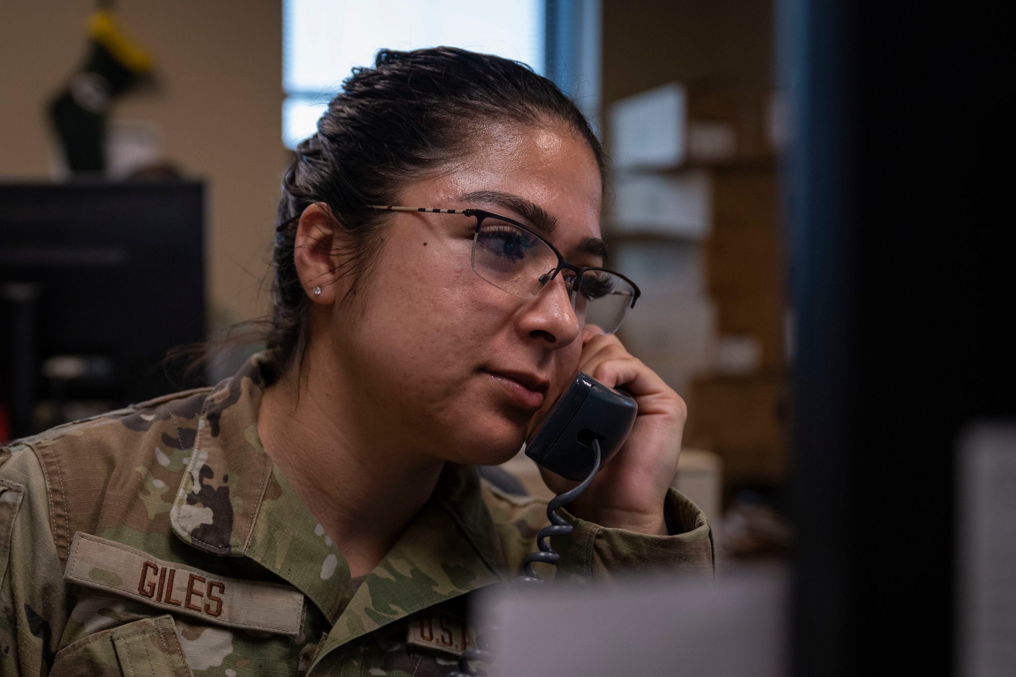 U.S. Airman 1st Class Diana Giles, 4th Fighter Wing judge advocate general corpsman, talks on the phone at Seymour Johnson Air Force Base, North Carolina, June 21, 2023. The 4th FW legal office is responsible for providing legal assistance to more than 25,000 retired and active-duty military members. (U.S. Air Force photo by Senior Airman David Lynn)